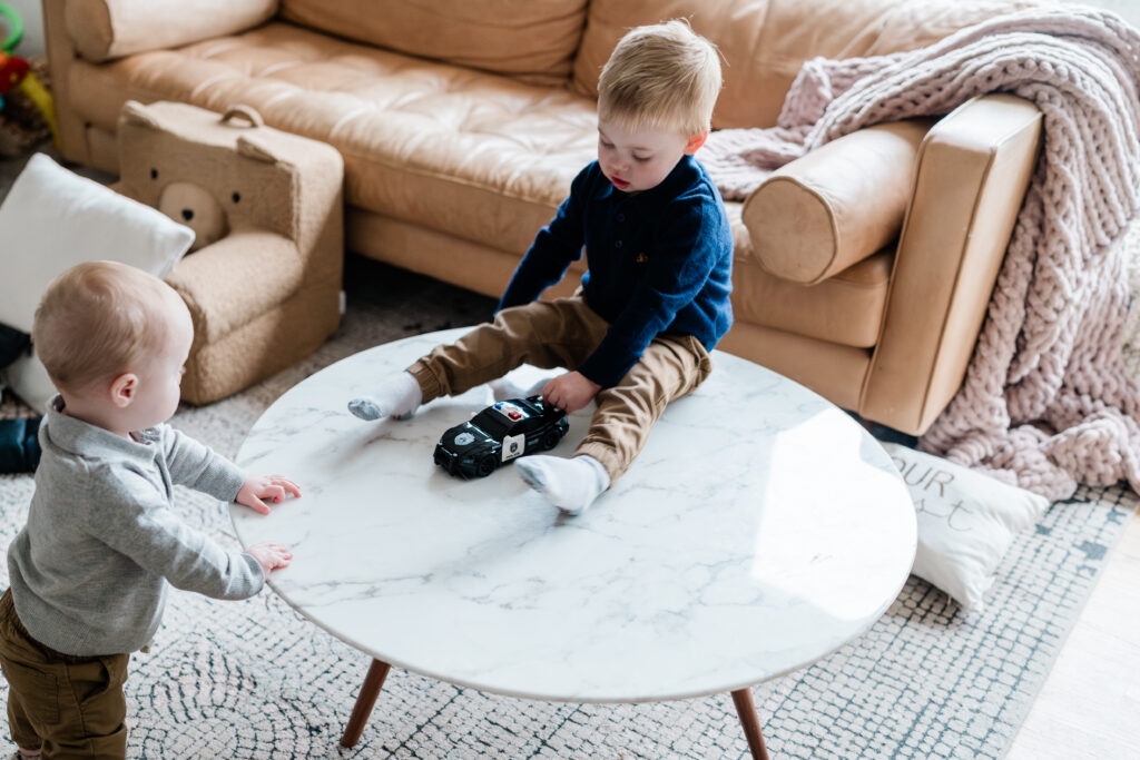 brothers playing together at home during their in-home lifestyle family photoshoot in Minneapolis, MN.